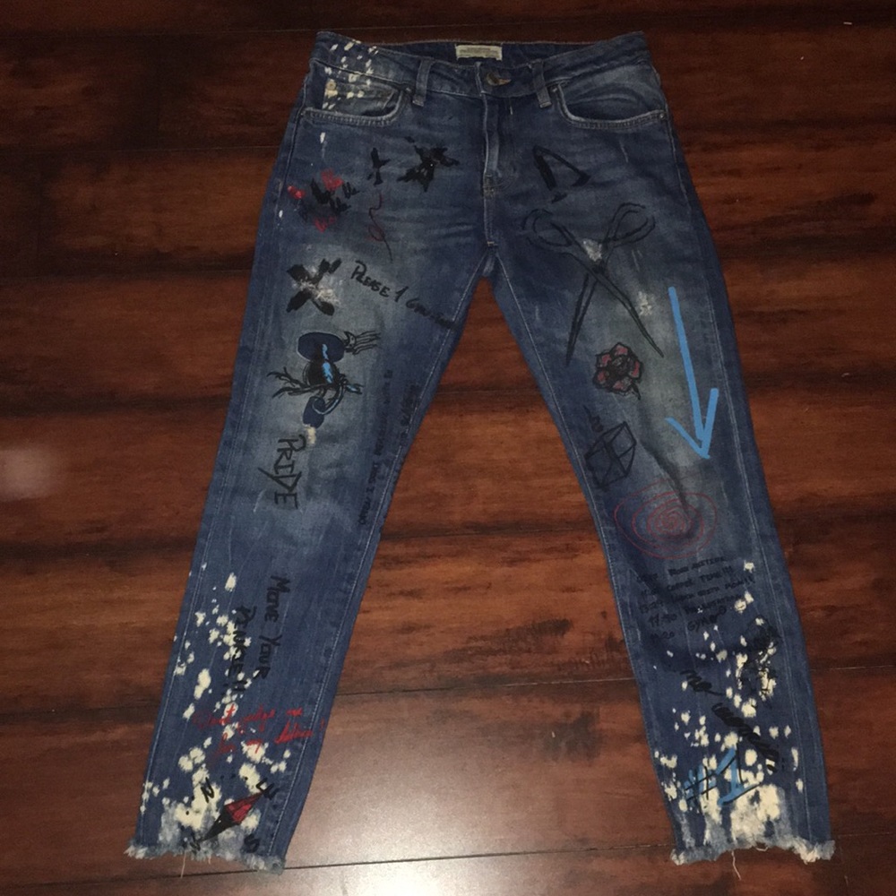 Denim jeans with art work and paint splatter